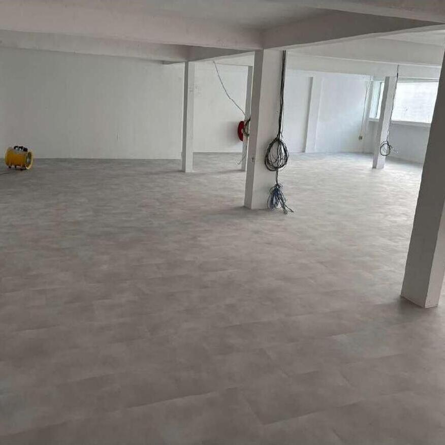 DS Flooring — large commercial space with light-grey luxury vinyl flooring